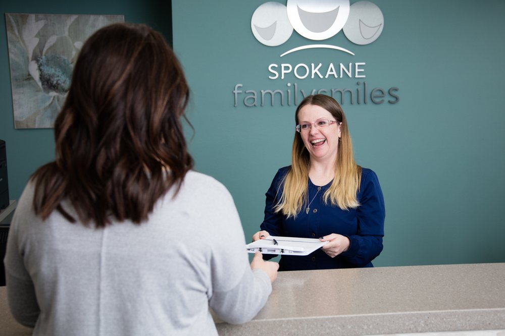 Friendly Spokane Family Smiles front desk team assisting patient