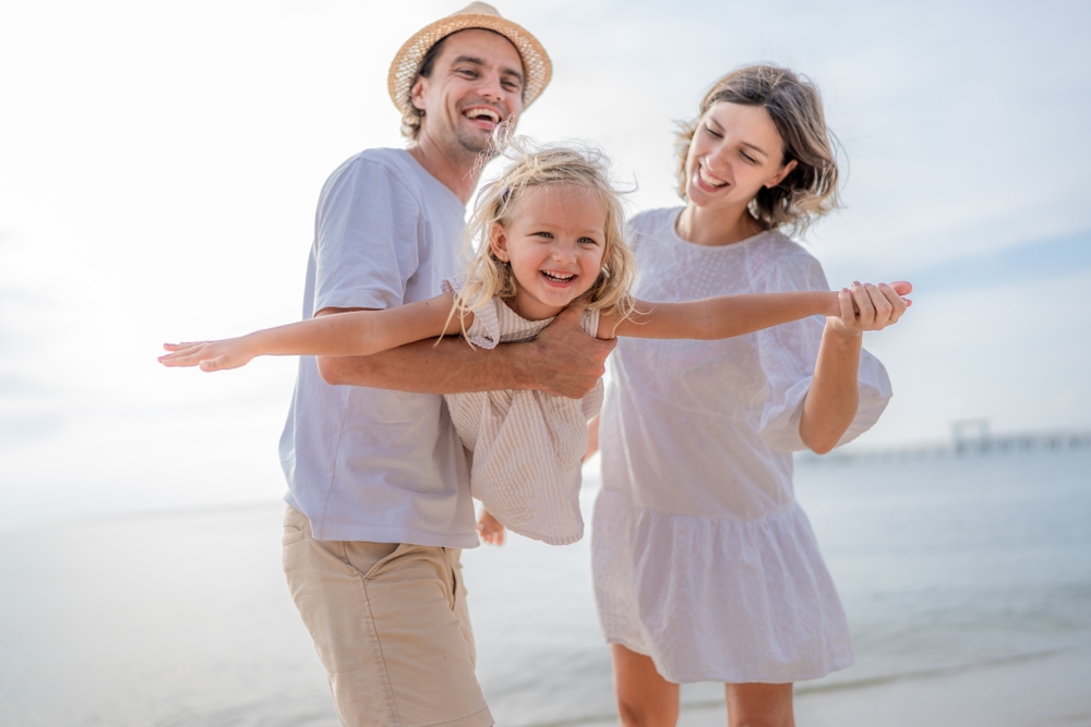 Happy family smiling together at Spokane Valley family dentist office after Restorative Dentistry