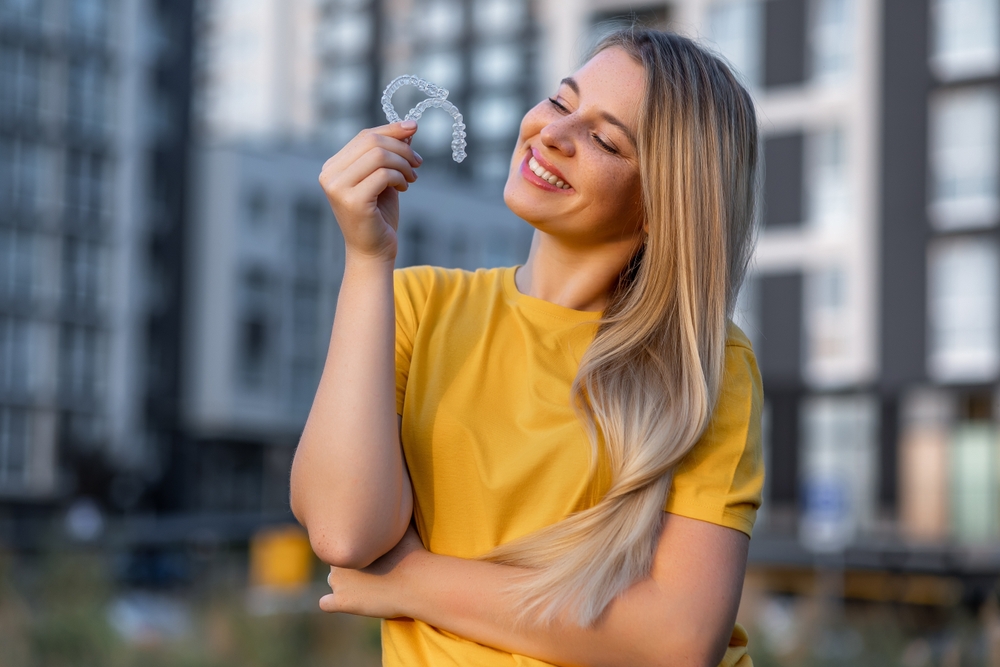 Woman holding Invisalign aligners in Spokane Valley