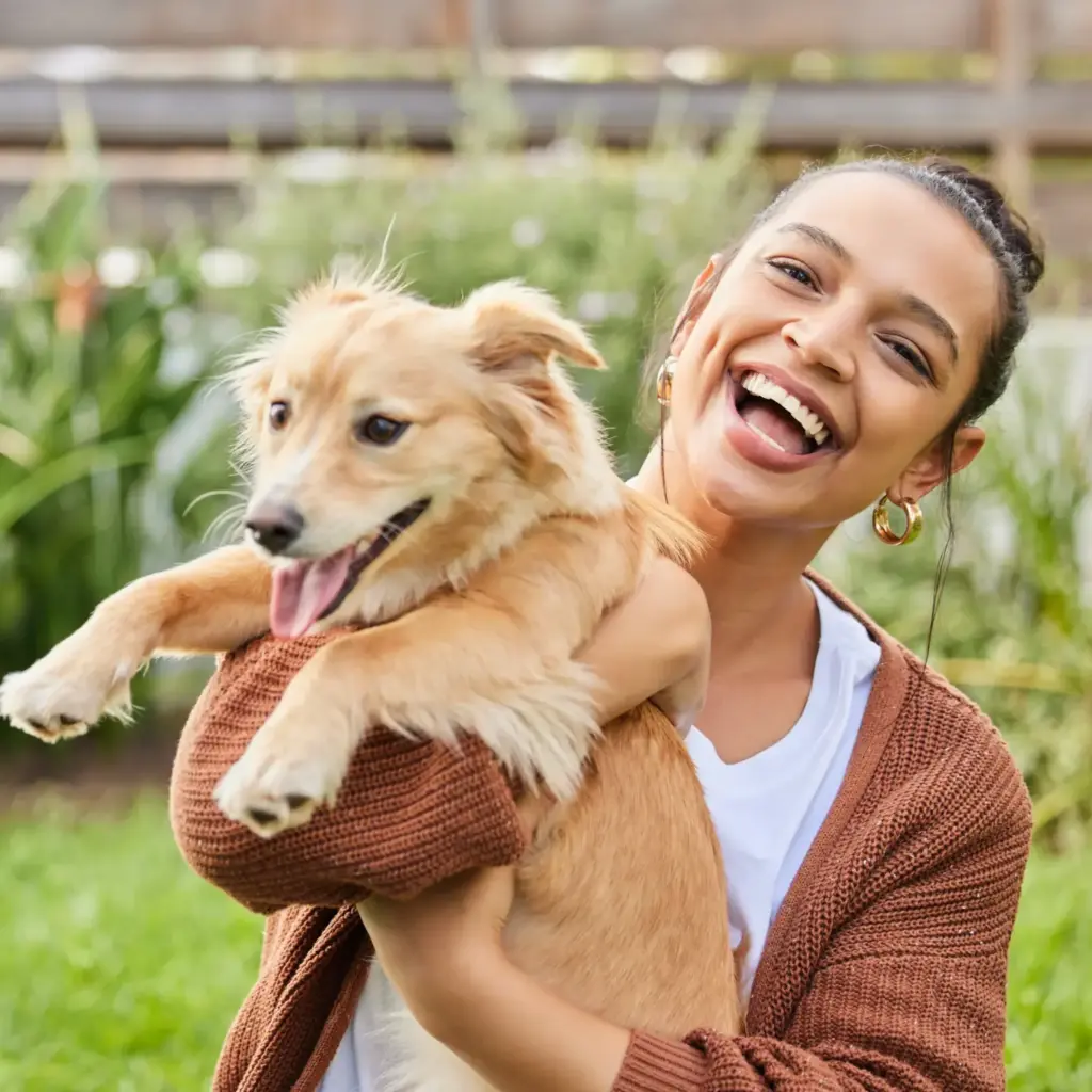 Woman smiling while holding her dog in Spokane Valley after Deep Cleaning